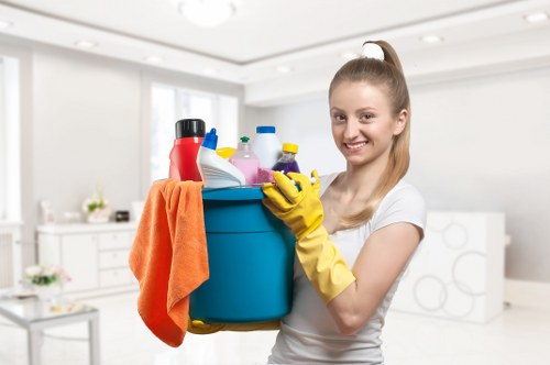 Technician using PPE during professional carpet cleaning in Islington